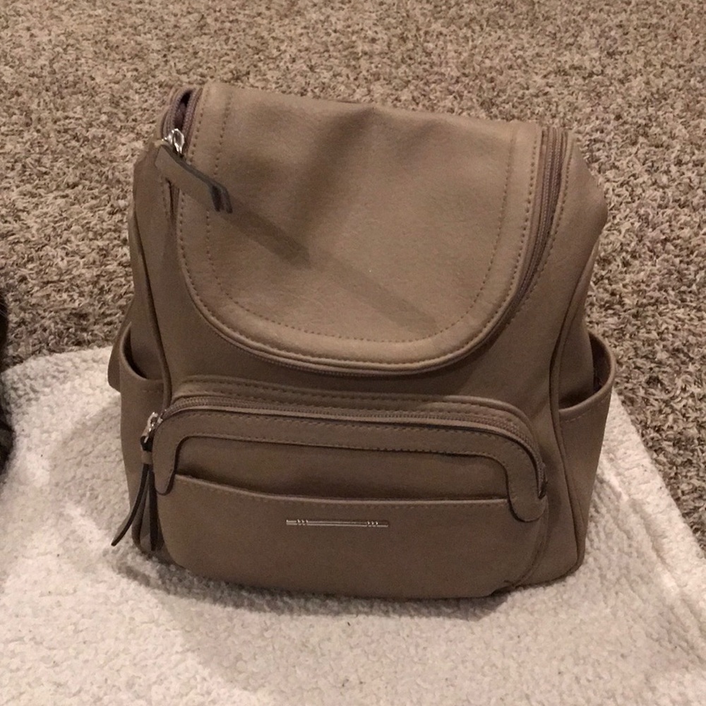 Beige backpack purse with adjustable straps